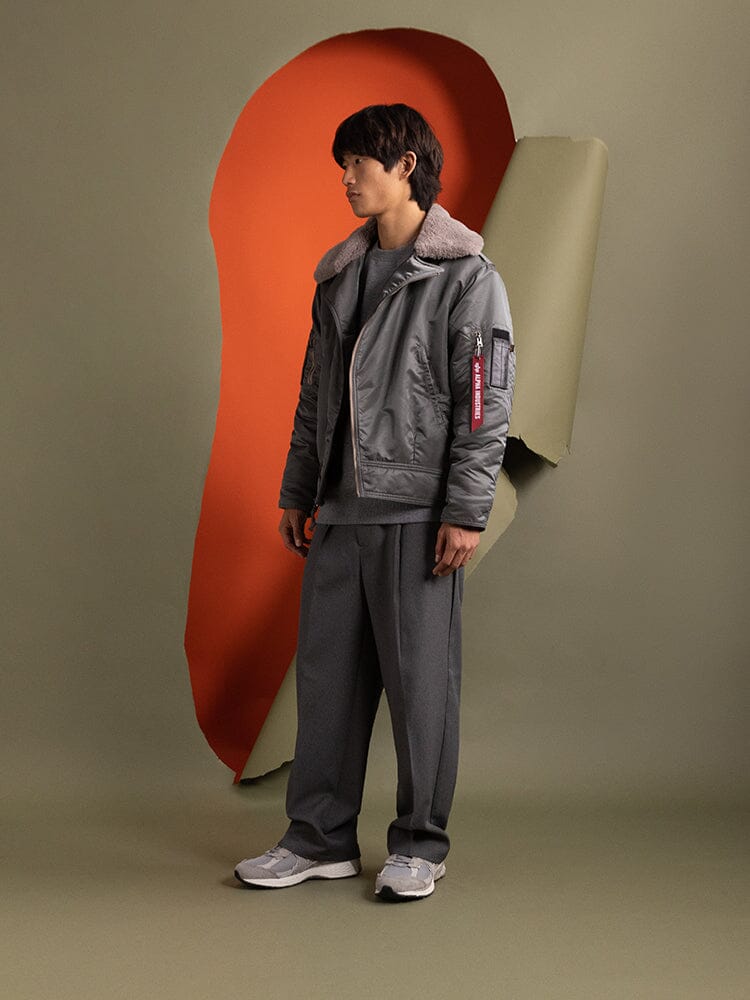 Side view of a person wearing the 1960s RCAF Canadian Airforce Type III Jacket in field gray by Alpha Industries.