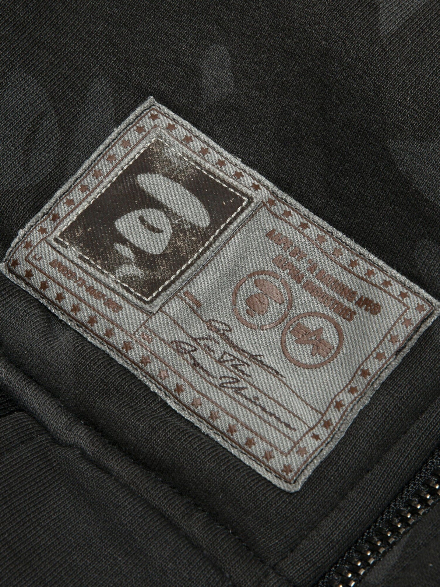 Aape X Alpha Reversible Padded MA-1 Quilted Jacket by Alpha Industries, fabric patch with stitched edges and printed abstract designs.