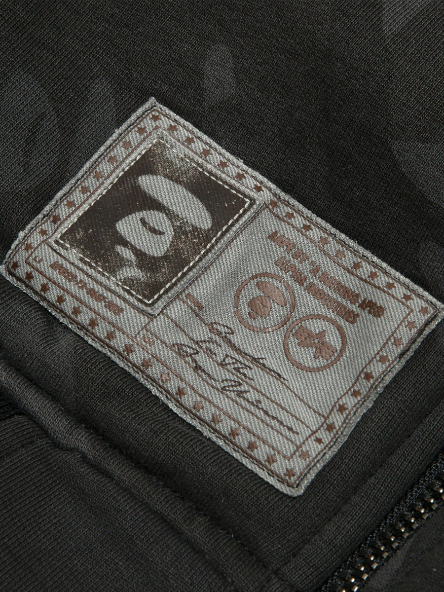 Aape X Alpha Reversible Padded MA-1 Quilted Jacket by Alpha Industries, fabric patch with stitched edges and printed abstract designs.