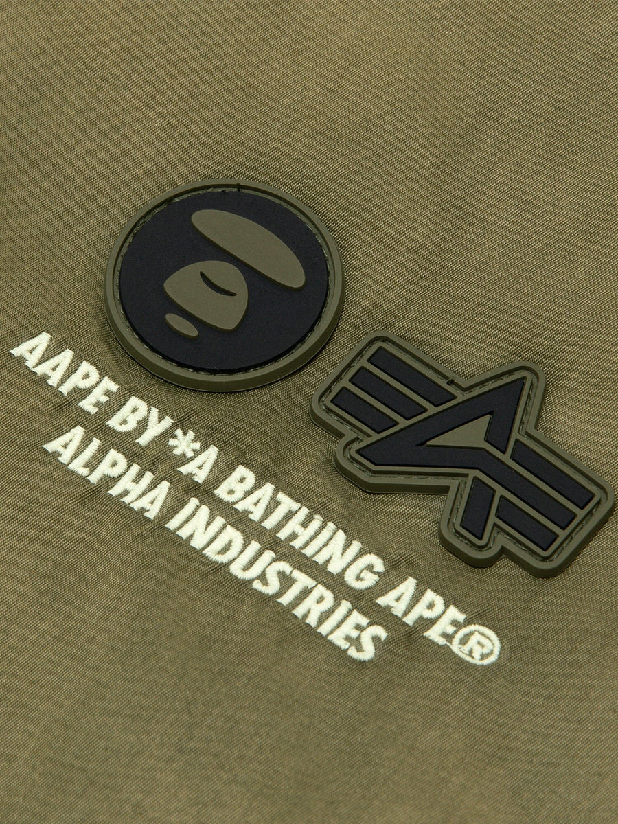 Aape X Alpha Reversible Padded MA-1 Quilted Jacket by Alpha Industries, khaki fabric with raised rubber ape head and A logo patches.