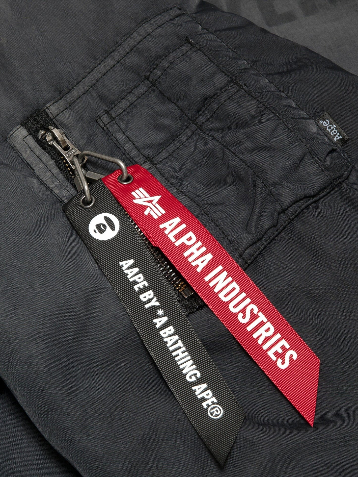 Aape X Alpha Reversible Padded MA-1 Quilted Jacket by Alpha Industries, black, zipper closure with red Alpha Industries tag and black Aape By *A Bathing Ape® tag.