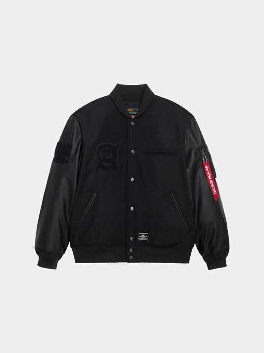 Alpha Industries Alpha Letterman Jacket in black with wool blend body, faux leather sleeves, snap buttons, chest pocket, embroidered large A patch, red zipper tag on right sleeve.