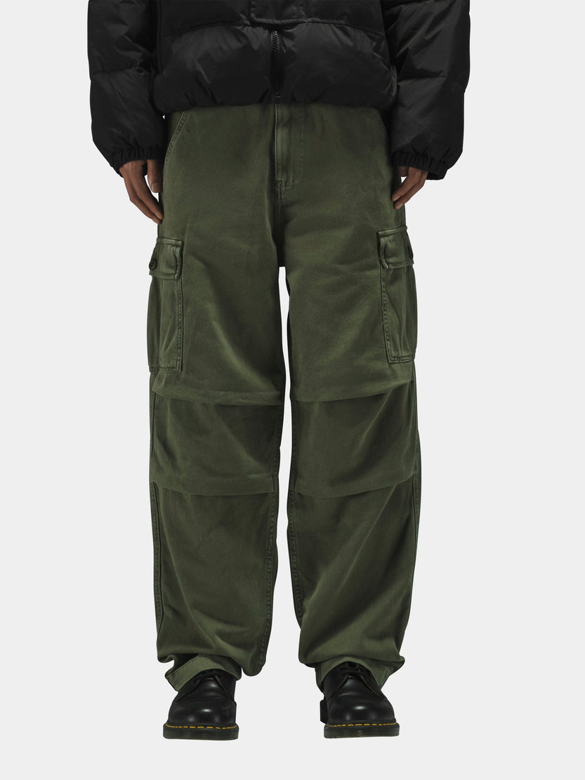 Alpha Industries Bdu Cargo Pant in olive green with black puffer jacket and black shoes.