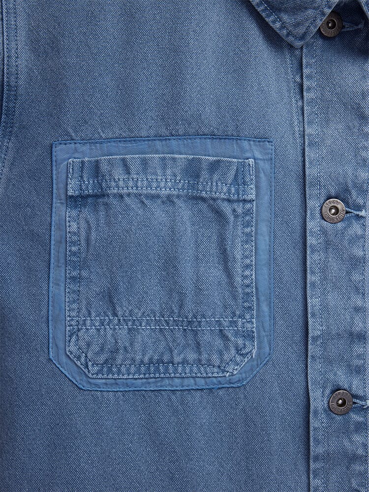 Alpha Industries CTN Chore Coat, blue denim cotton jacket with garment-washed finish, chest pocket with visible stitching, metal buttons down the placket.