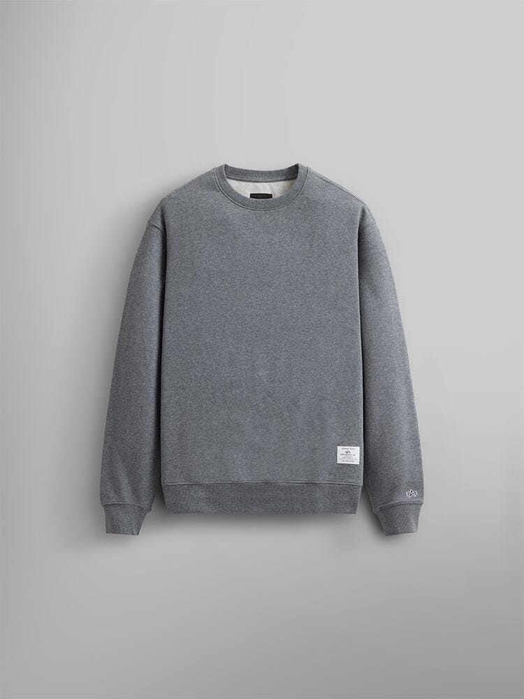 A Plain Unisex Crewneck Sweatshirt in Medium Charcoal Heather Featuring a Small Alpha Industries Logo Near the Hem.
