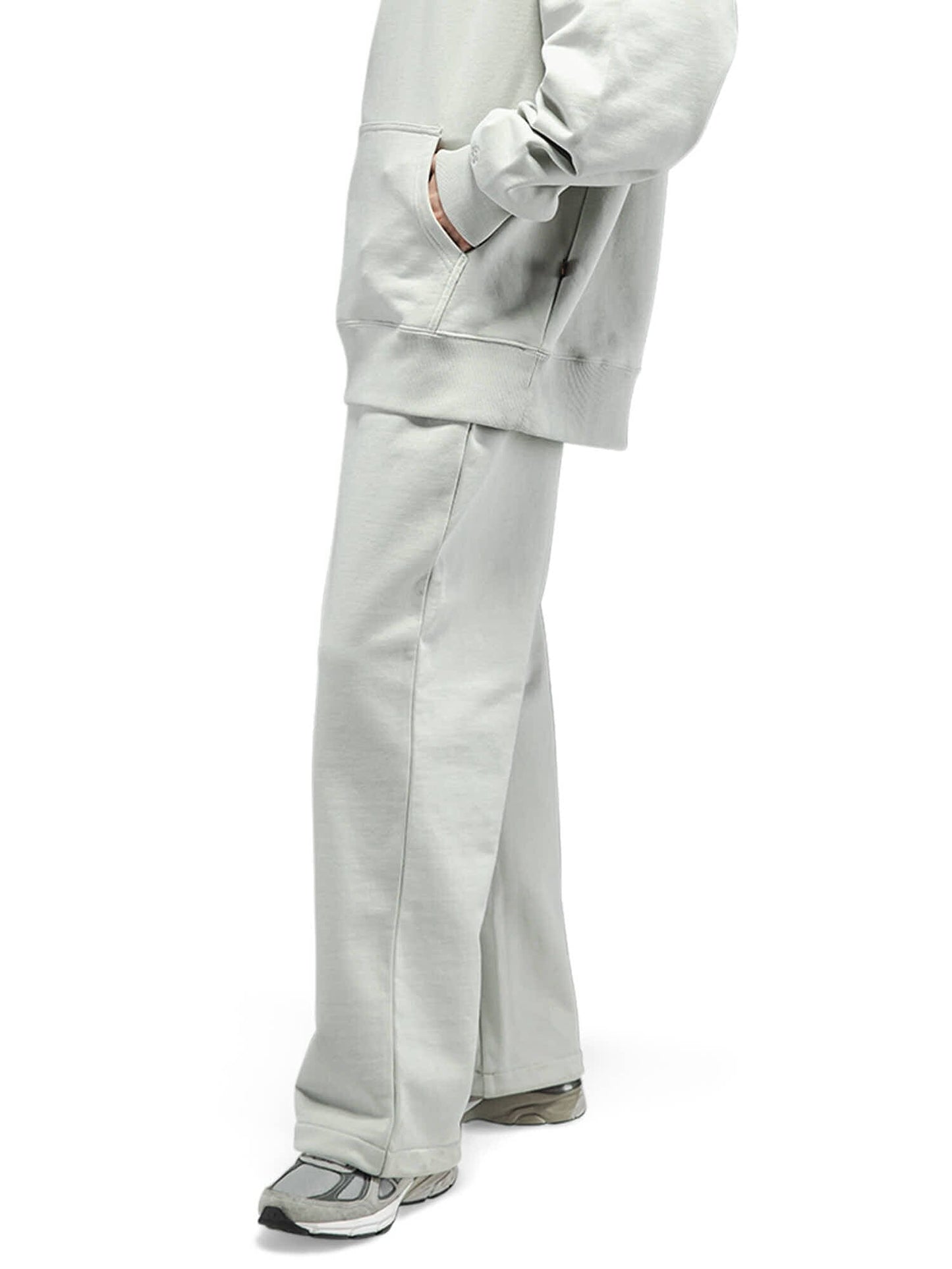 Alpha Industries Essential French Terry Sweatpant in light gray with matching sweatshirt and gray sneakers.