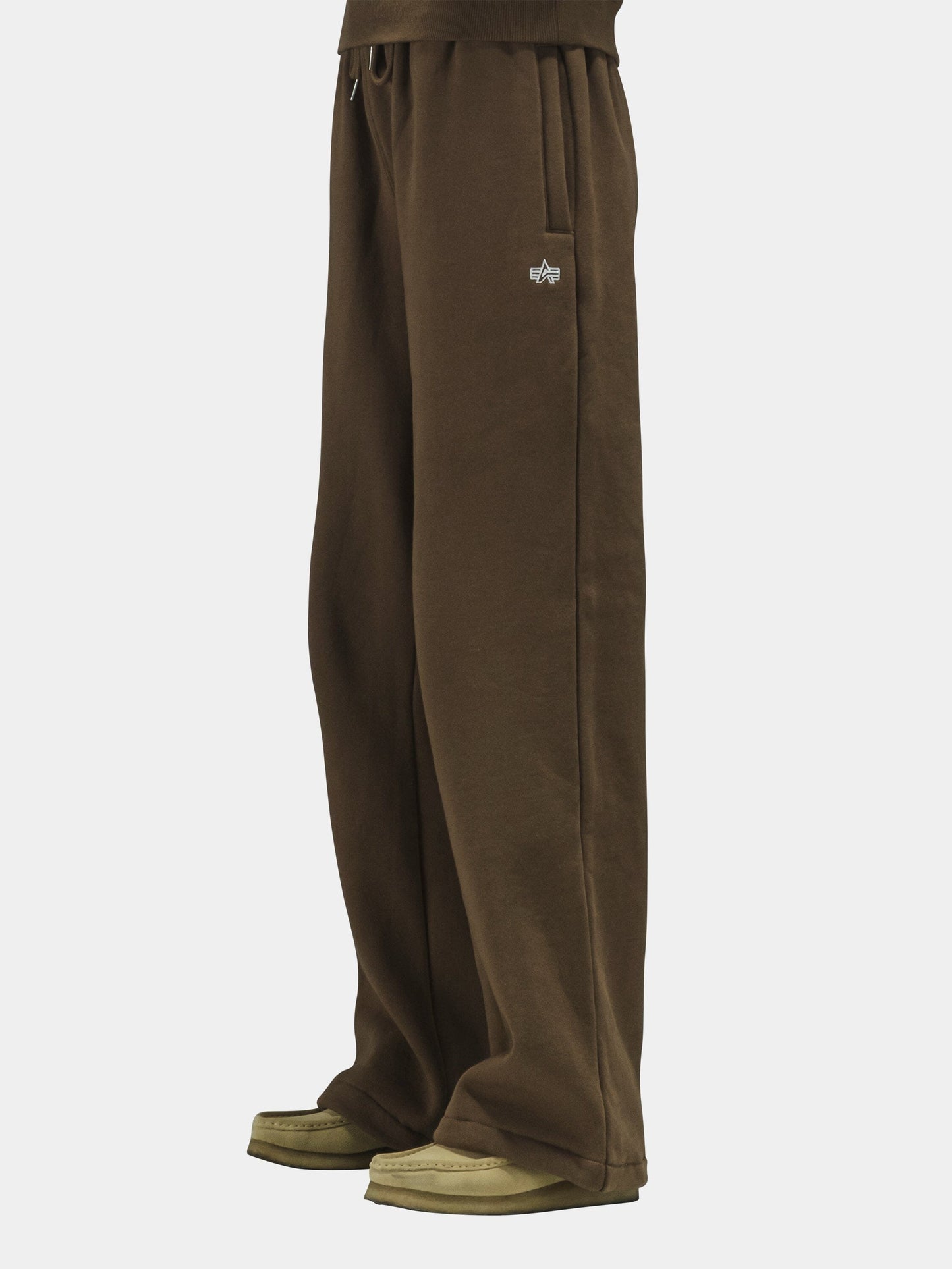 Alpha Industries Essential Sweatpants in cotton, with beige and brown shoes.