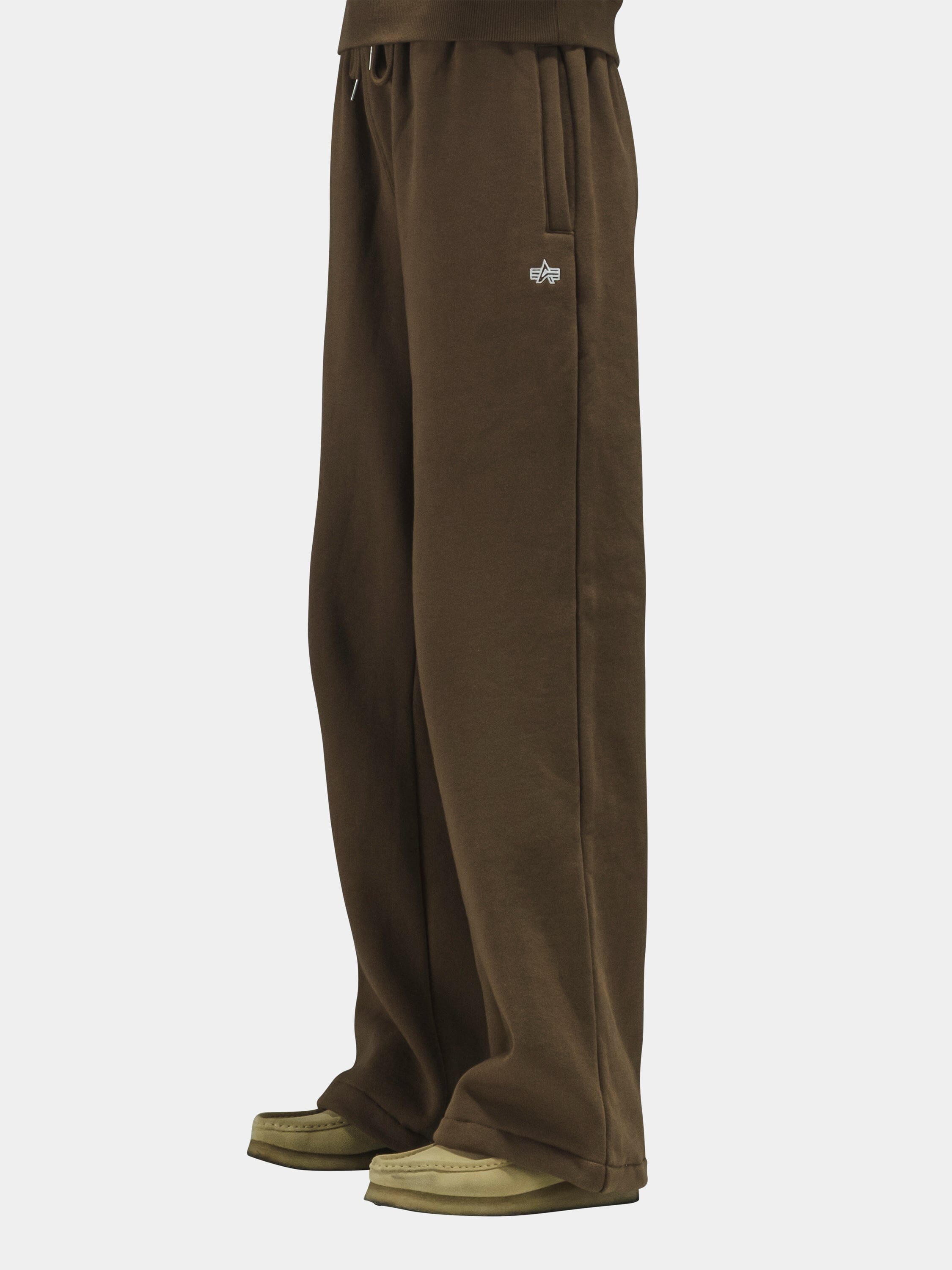 Alpha Industries Essential Sweatpants in cotton, with beige and brown shoes.