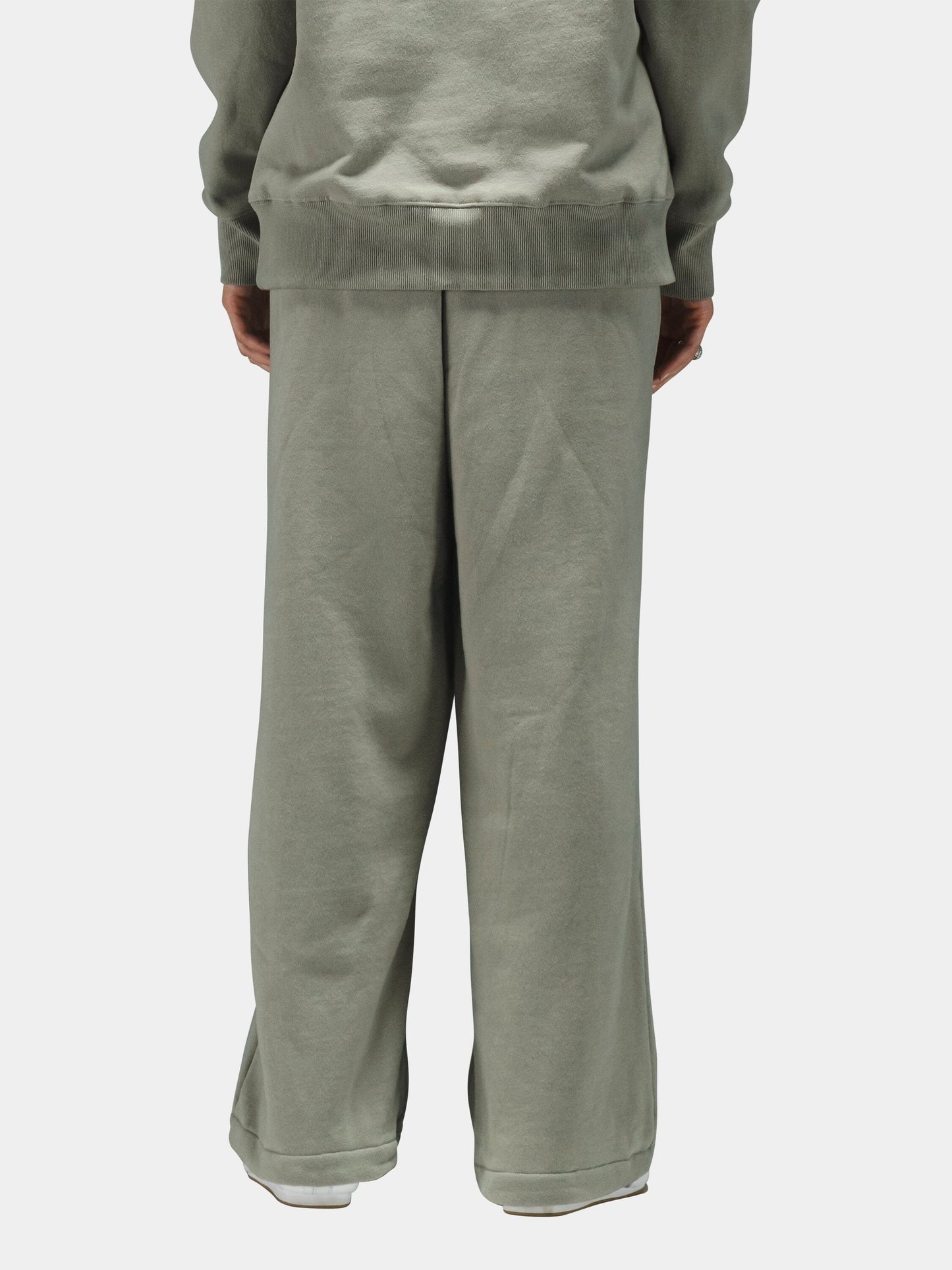 Alpha Industries Essential Sweatpants in light sage green cotton, paired with matching sweatshirt.