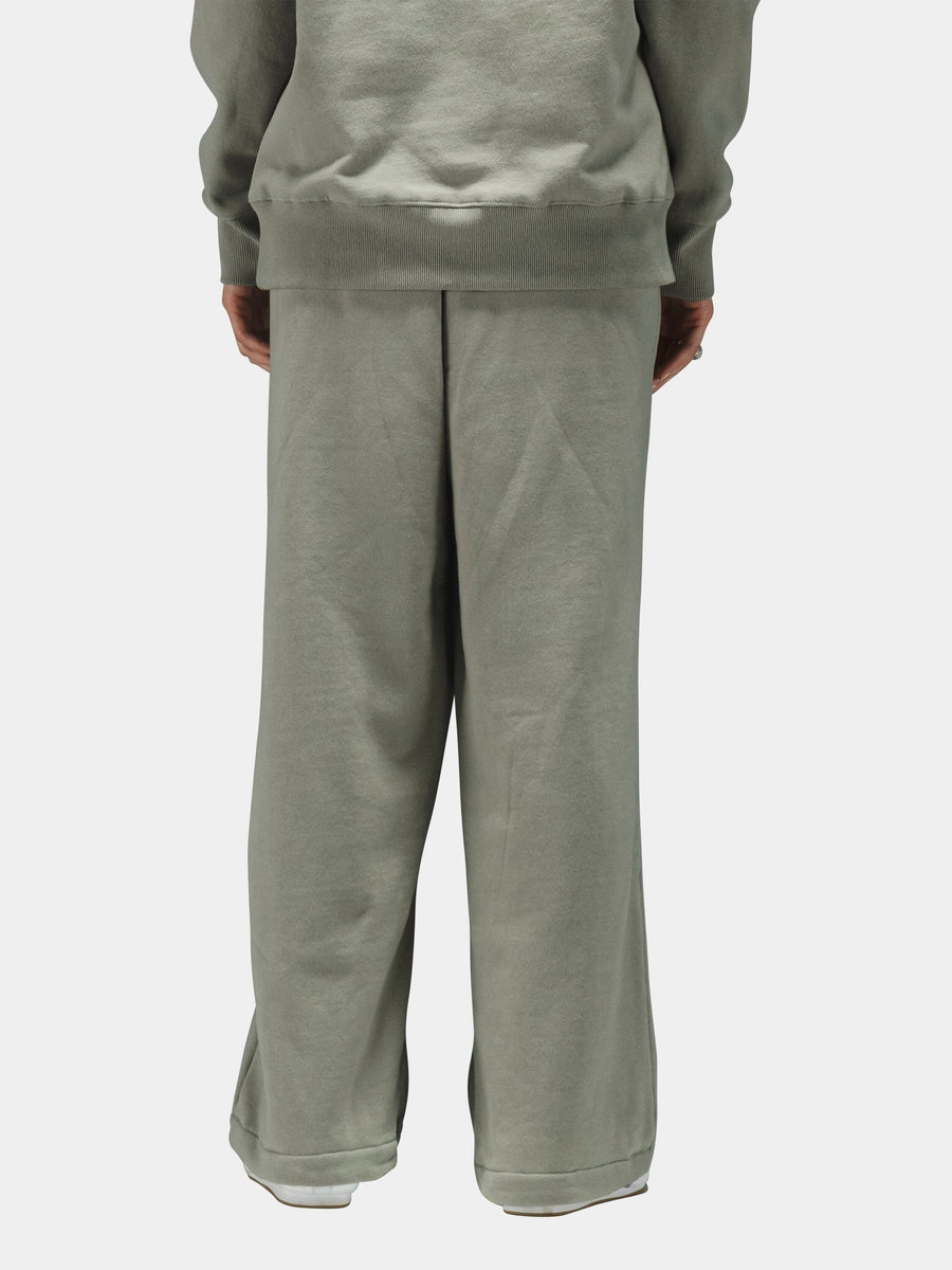 Alpha Industries Essential Sweatpants in light sage green cotton, paired with matching sweatshirt.