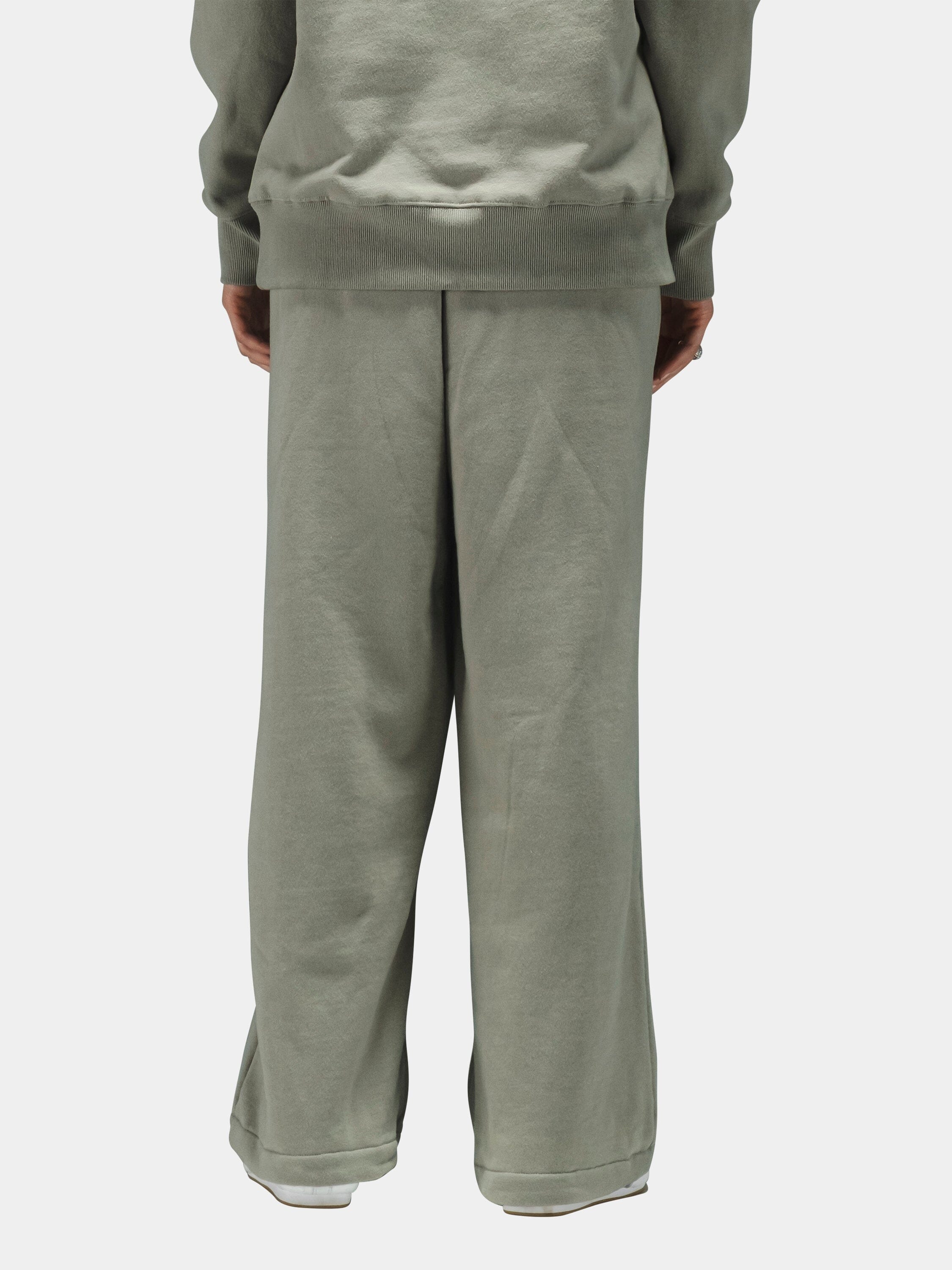 Alpha Industries Essential Sweatpants in light sage green cotton, paired with matching sweatshirt.