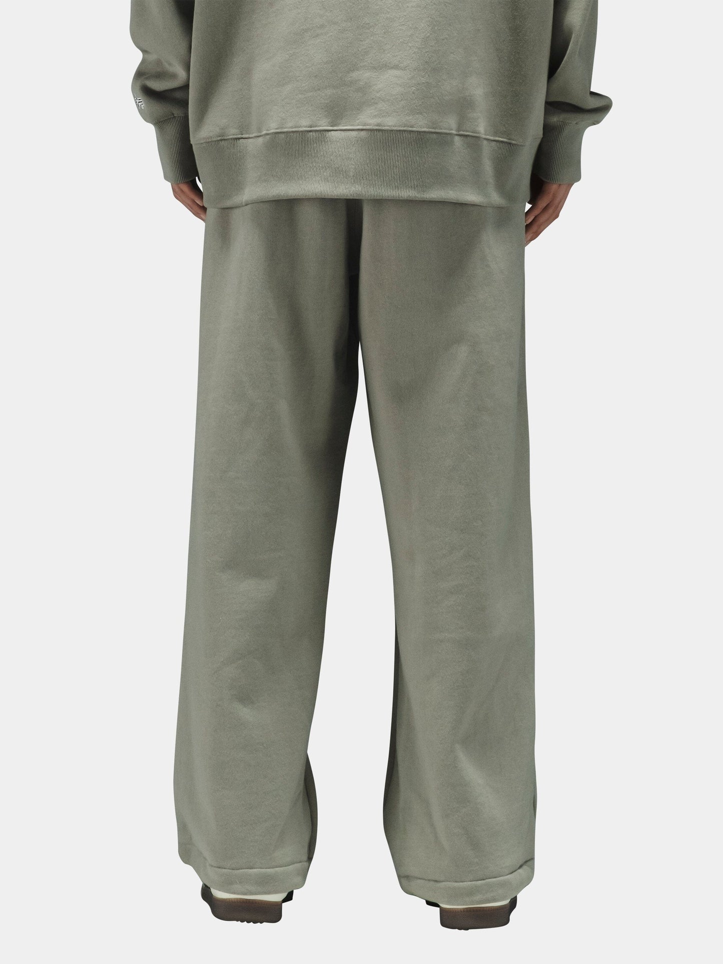 Alpha Industries Essential Sweatpants in sage green cotton, loose fit, with matching oversized sweatshirt.
