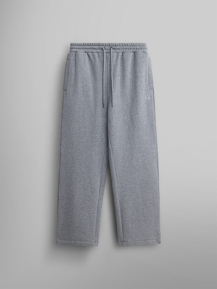 The Women's Essential Sweatpants by Alpha Industries are made from soft cotton fabric in a medium charcoal heather color. They feature an elastic waistband with a drawstring, two side pockets, and a small embroidered logo on the left side for understated style.