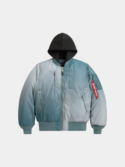 Alpha Industries Gradient Washed Flight Jacket in Aviator Blue with gradient design, black hood, front zipper, zippered pockets, red Remove Before Flight tag.