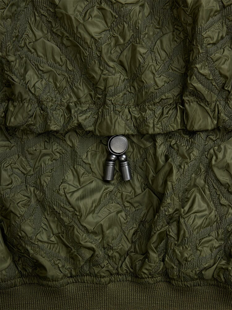 Alpha Industries L-2B Bubble Flight Jacket, olive green outer shell with black plastic adjustable cord lock.