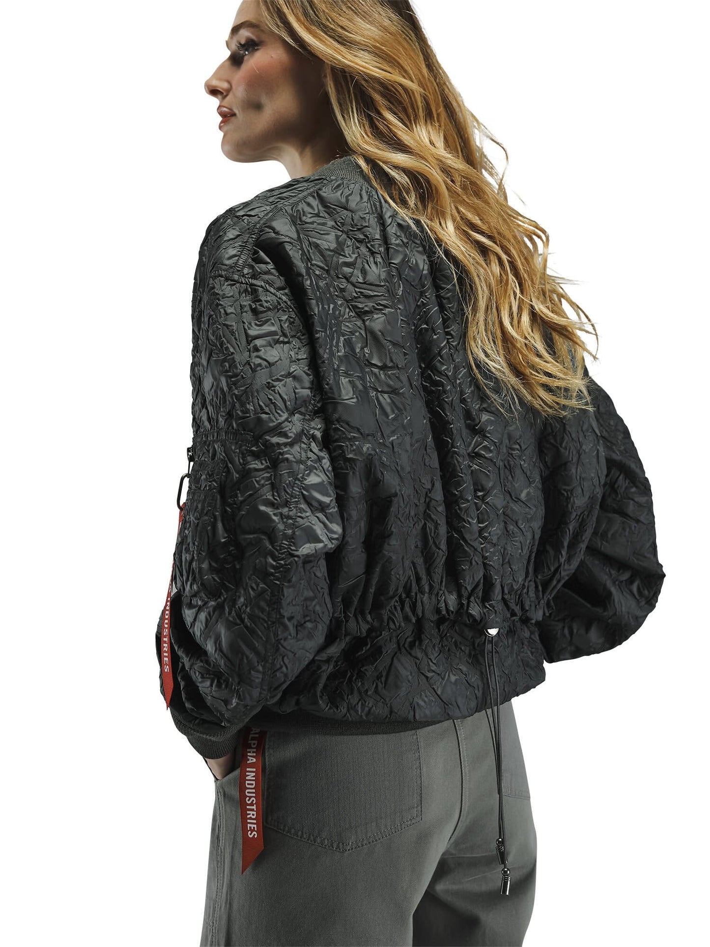 Alpha Industries L-2B Bubble Flight Jacket W, textured black outer shell, gray pants.