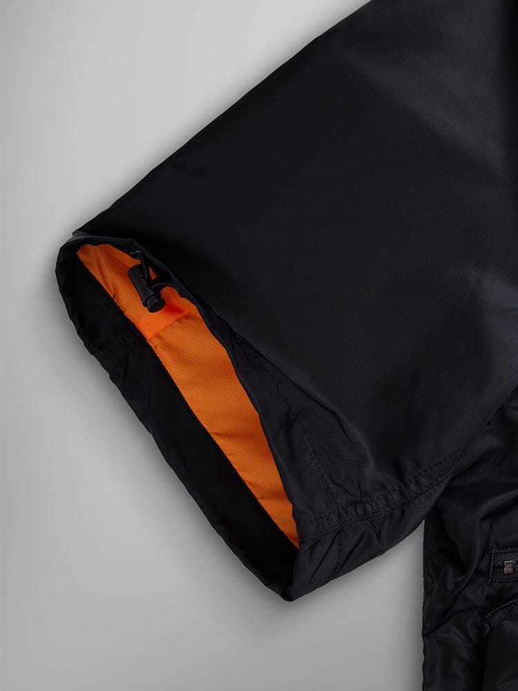 Alpha Industries L-2B Short Sleeve Bomber Jacket, black water-resistant nylon, orange lining, utility pocket, black drawstring toggle.