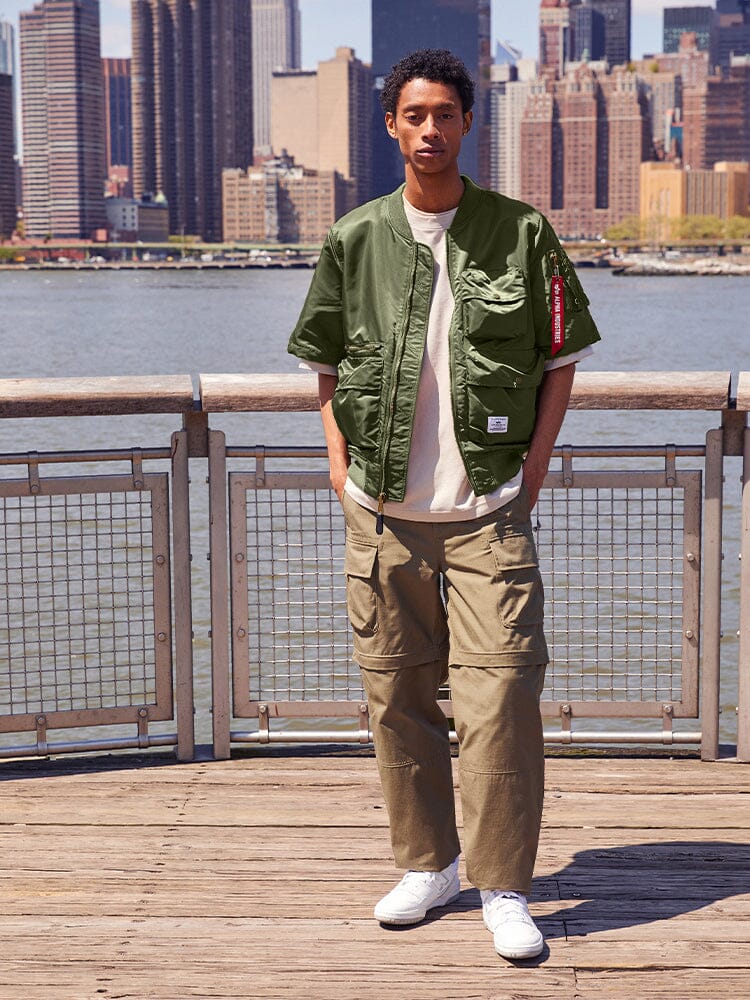 Alpha Industries L-2B Short Sleeve Bomber Jacket in olive green, with front zipper closure and pocket details.