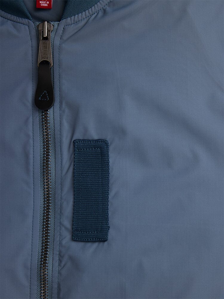 Alpha Industries L-2b Skymaster Gen II Bomber Jacket, large metal zipper, rectangular fabric patch with oxygen tab details, red label near collar.