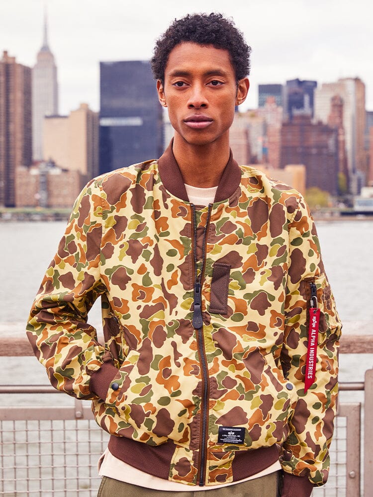 Alpha Industries L-2B Skymaster Gen II Bomber Jacket, brown and green camouflage, zip closure.