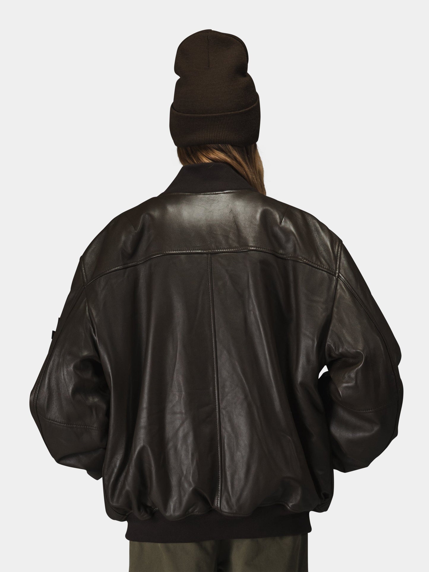 Alpha Industries Leather MA-1 Flight Jacket, dark brown beanie, leather material, MA-1 design.