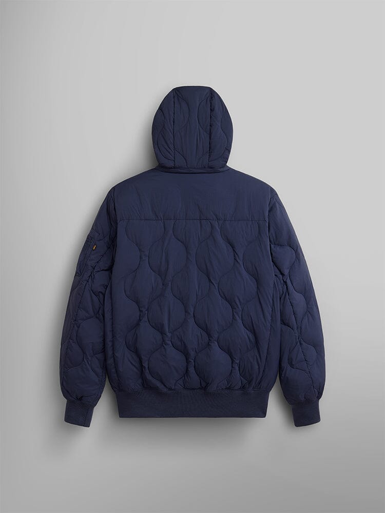 Back view of the lightweight quilted down jacket, in navy, by Alpha Industries featuring a removable hood and a wavy stitching pattern with ribbed cuffs.