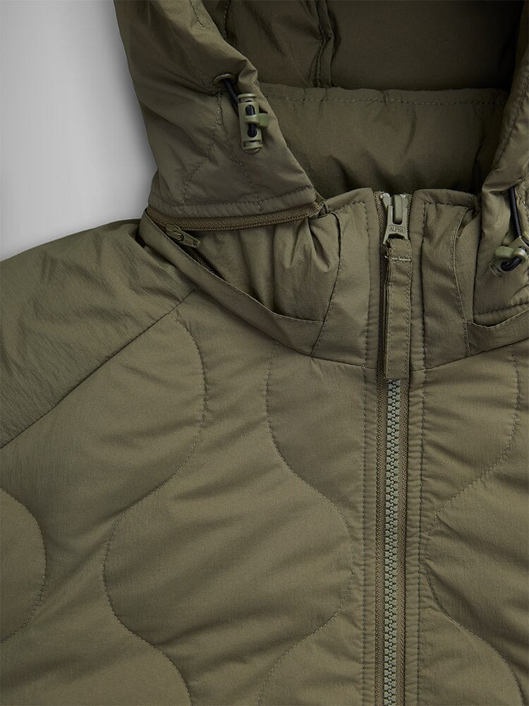 Close-up of the Alpha Industries Lightweight Quilted Down Jacket in olive green, featuring a quilted design, complete with a removable hood and a front zipper.