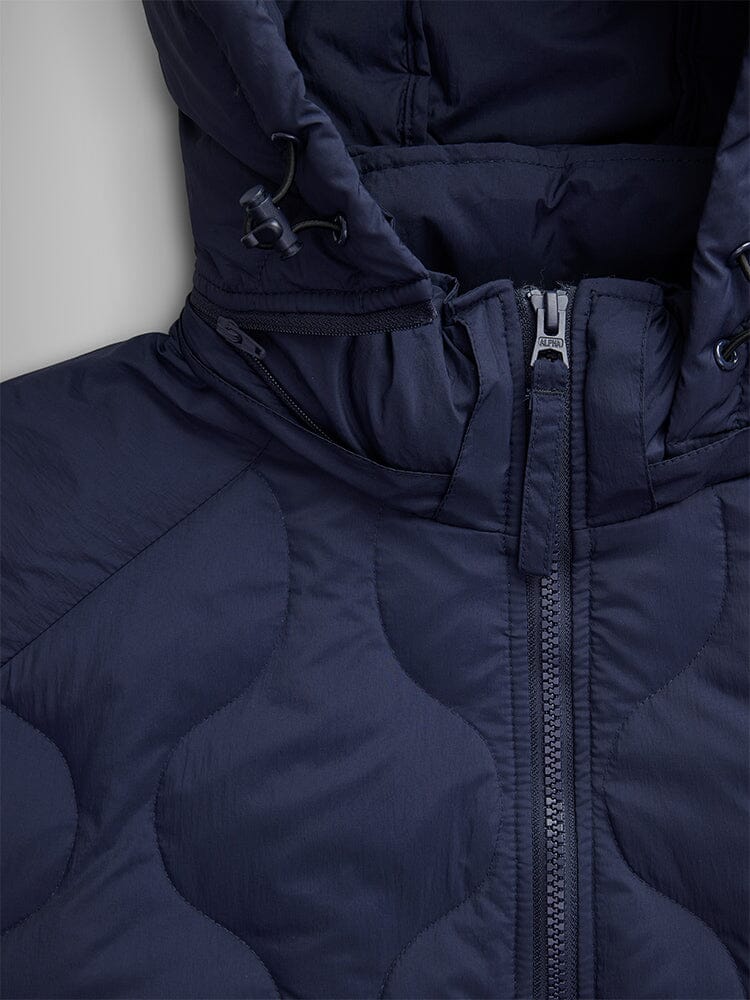 Close-up of the Lightweight Quilted Down Jacket in Navy Blue by Alpha Industries, featuring a removable hood and a visible zipper.