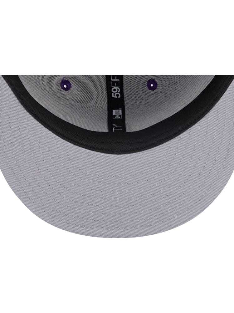 An underside view of the Los Angeles Lakers Alpha x New Era 59Fifty Fitted Cap's brim reveals a black inner lining and intricate stitching details, ideal for fans looking to add a touch of style.