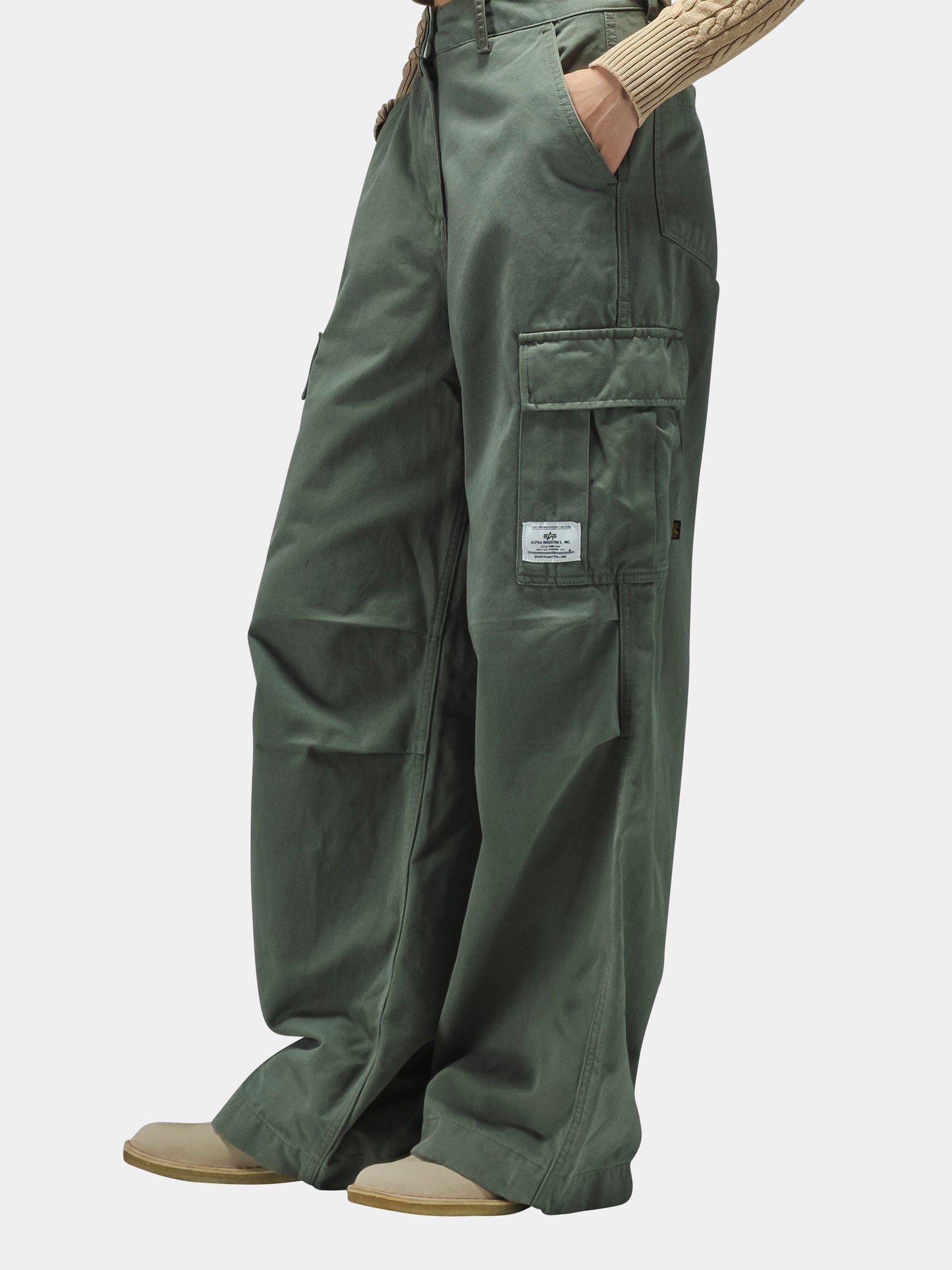 Alpha Industries M-65 Cargo Pant Womens with large cargo pockets and beige shoes.