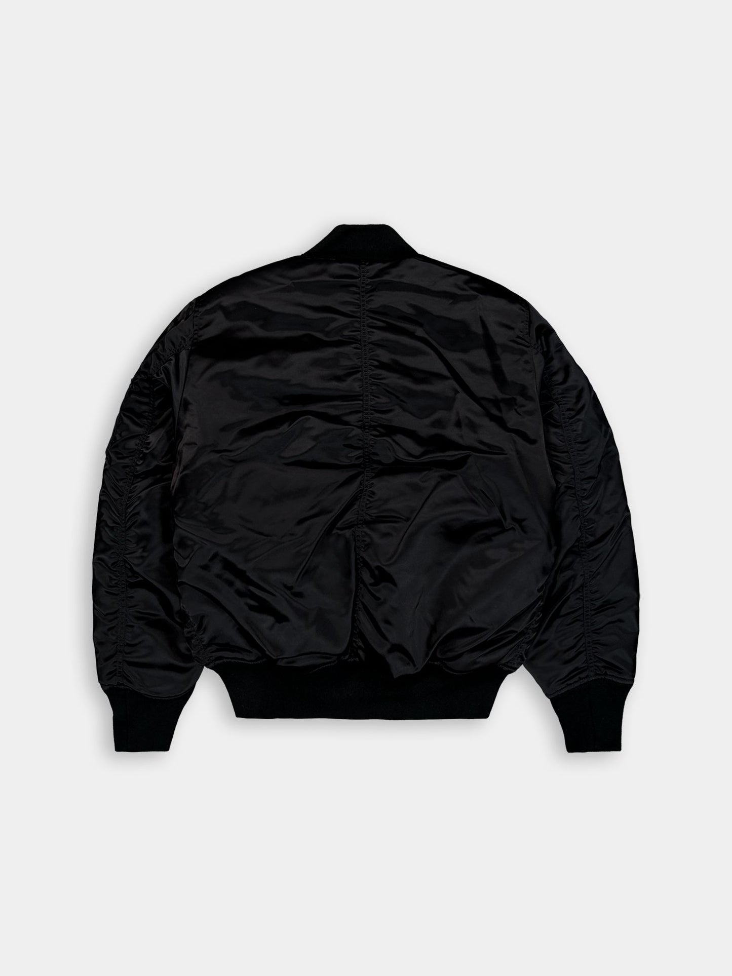 Alpha Industries MA-1 3M Base Flight Jacket in black, ribbed collar, cuffs, and hem.