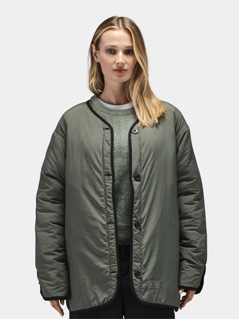 Alpha Industries Reversible Als/92 Mod Liner Womens in olive green nylon ripstop over a green sweater.