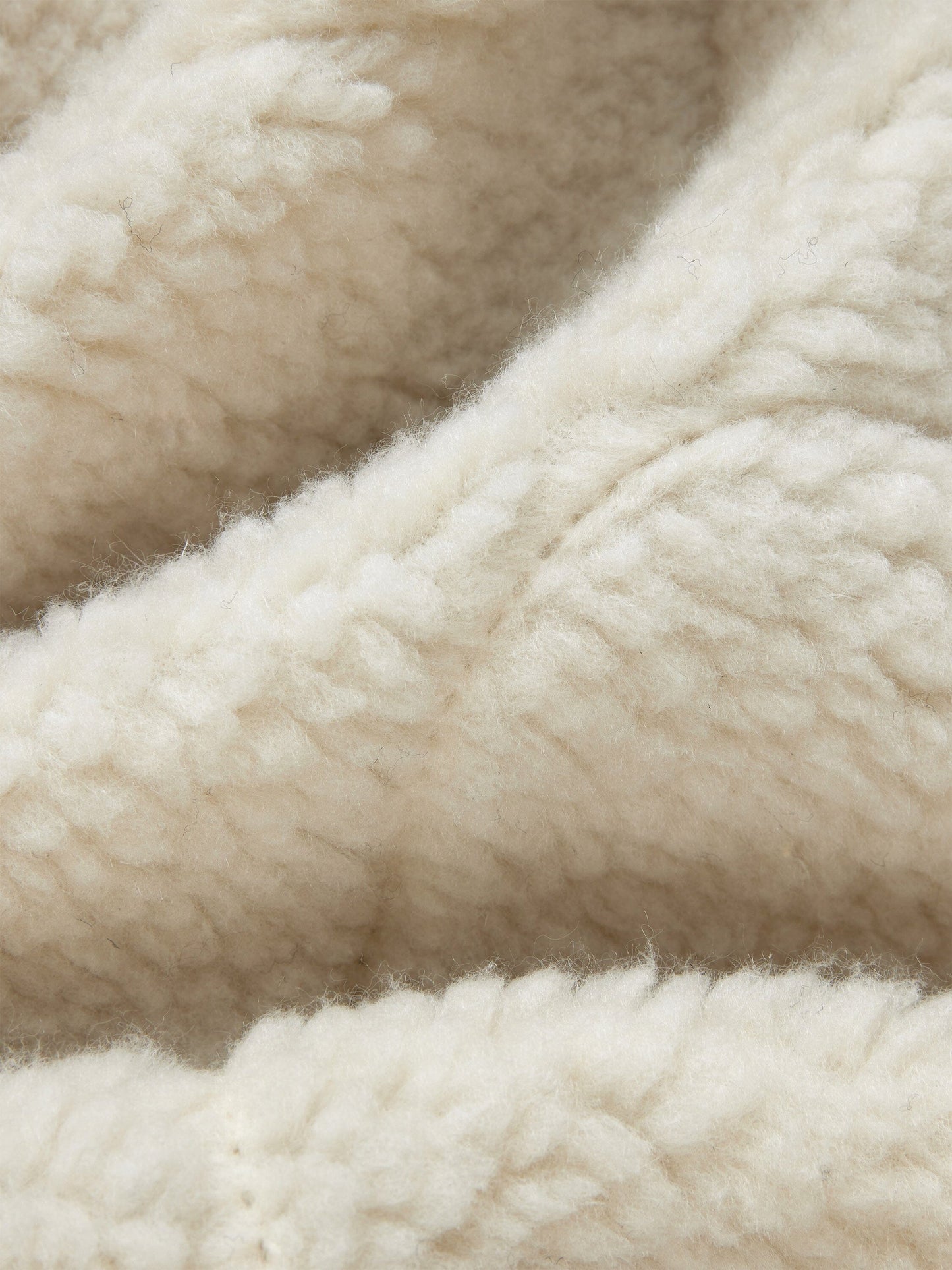 Sherpa Onion Quilting Vest by Alpha Industries featuring cream fleece fabric with textured surface and subtle folds.