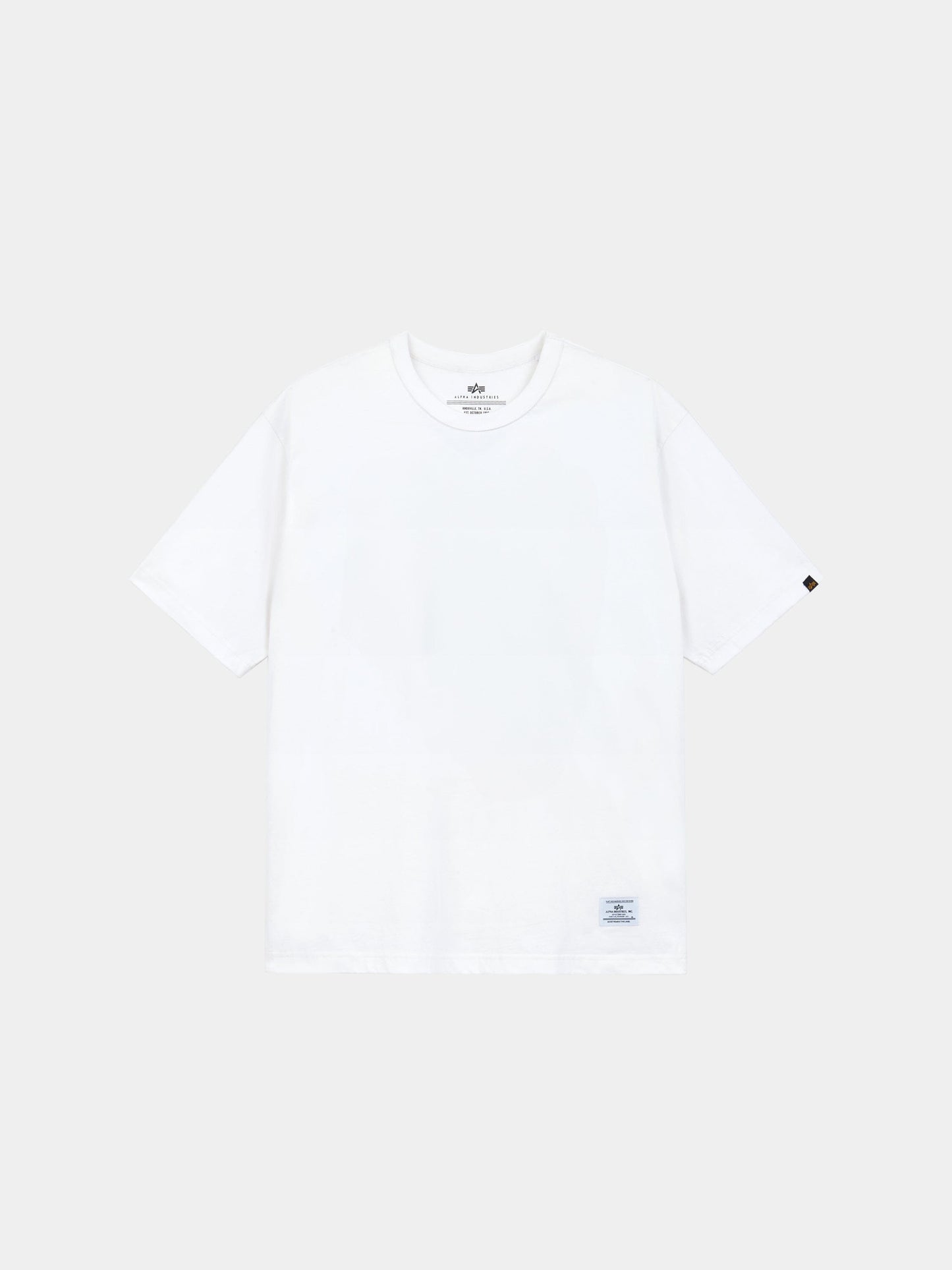 Alpha Industries Short Sleeve Patched Tee with small tag at hem and logo patch on left sleeve.