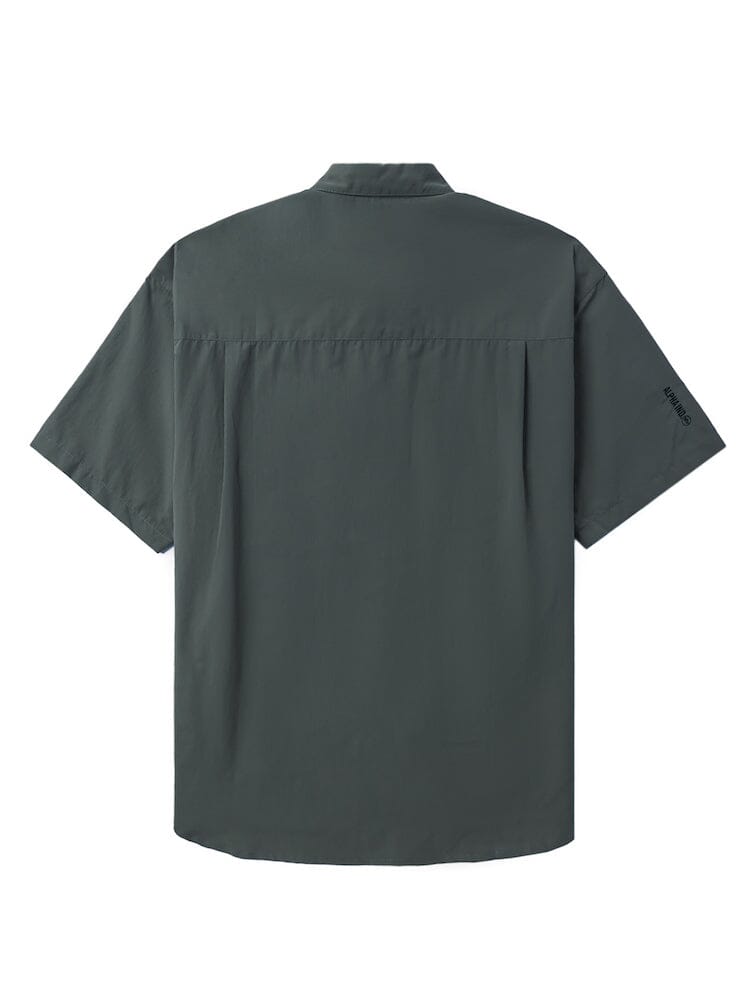 Unfrm Nylon Utility Shirt by Alpha Industries in dark green, nylon material, short sleeves, button front closures, plain design, small silicone Alpha logo on left sleeve.