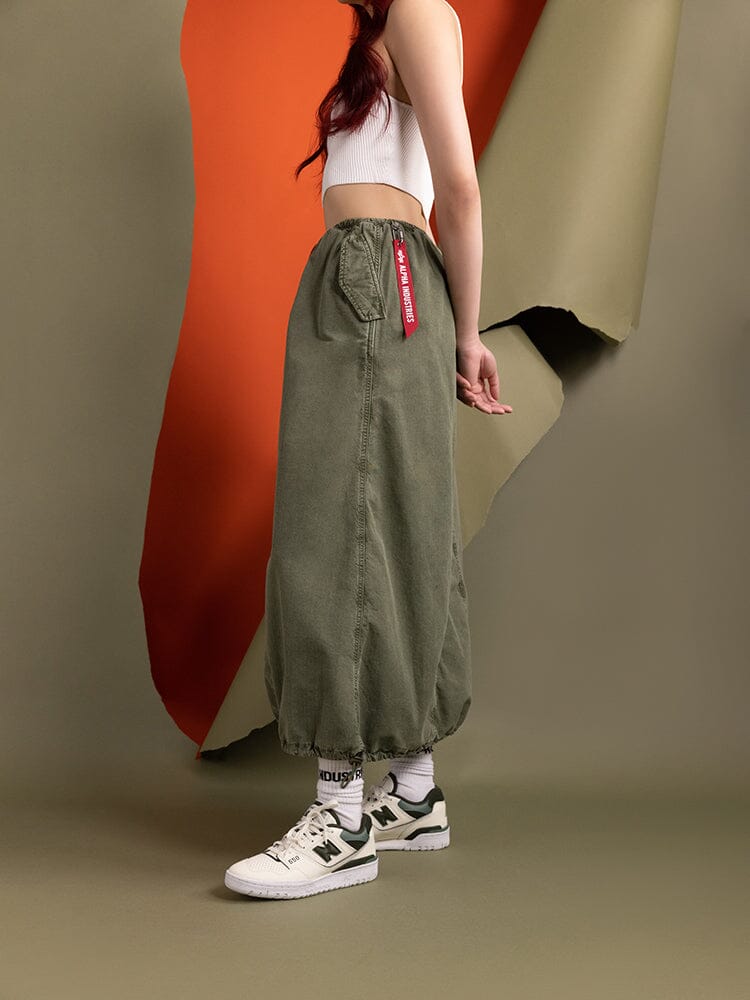 Side view of a person wearing the Women's Drawcord Skirt by Alpha Industries.