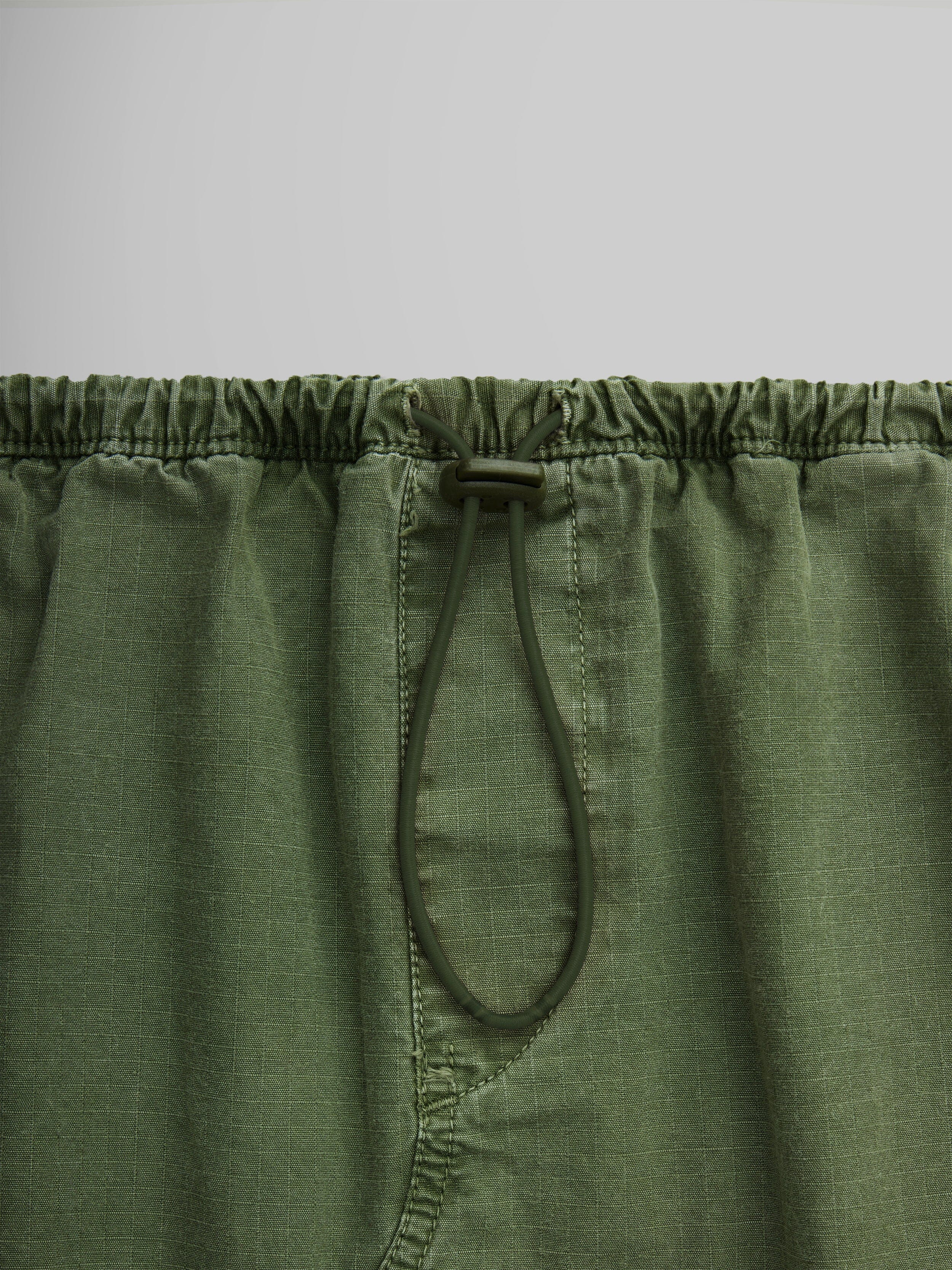 Close-up of the Women's Drawcord Skirt by Alpha Industries, with a convenient drawcord waistband and practical flap pockets.
