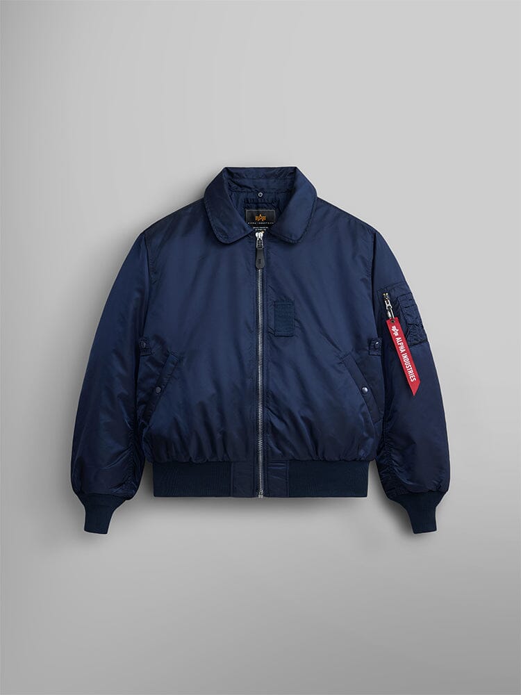 Alpha Industries B-15 Bomber Jacket in navy blue with front zipper, ribbed cuffs and hem, side pockets, red sleeve tag, removable faux-mouton collar.