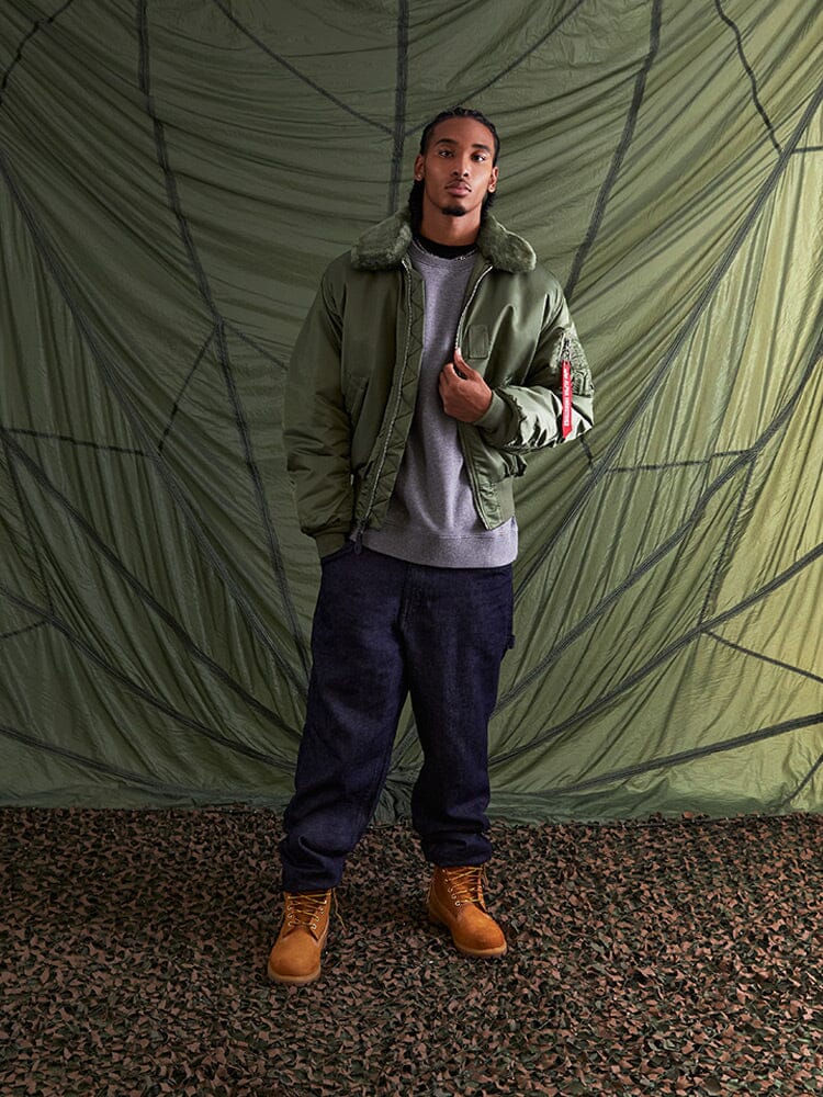 Alpha Industries B-15 Bomber Jacket in green with water resistance, removable faux-mouton collar, and MA-1 details.