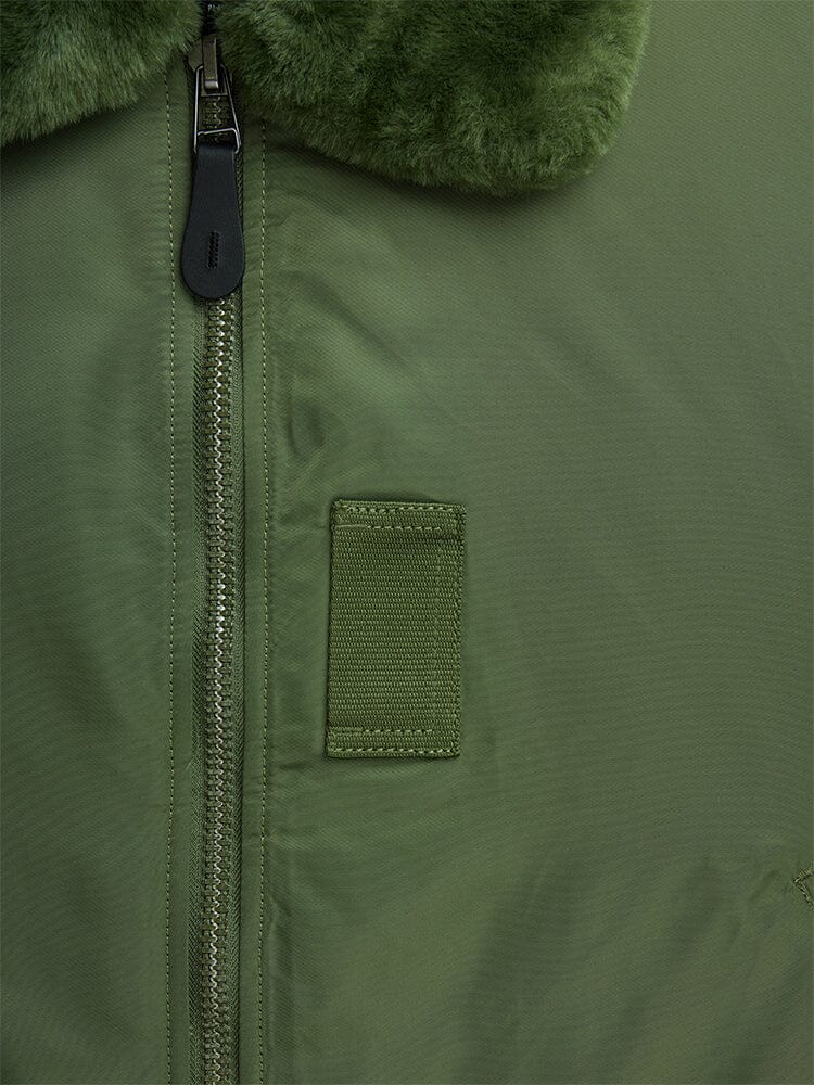 Alpha Industries B-15 Bomber Jacket in olive green with zipper, small rectangular patch, water-resistant fabric, and removable faux-mouton collar.