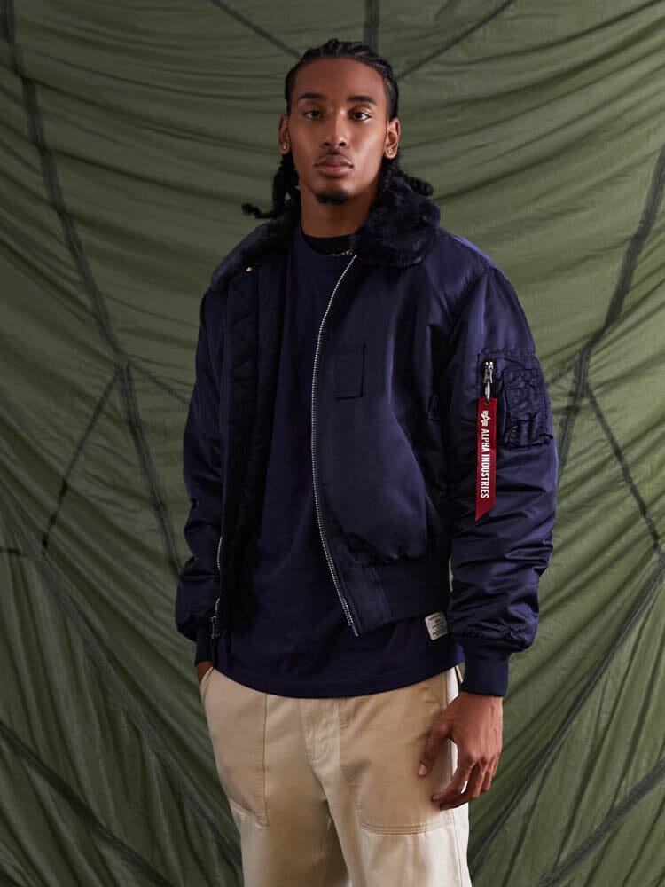 Alpha Industries B-15 Bomber Jacket in water-resistant navy with removable faux-mouton collar and red tag.