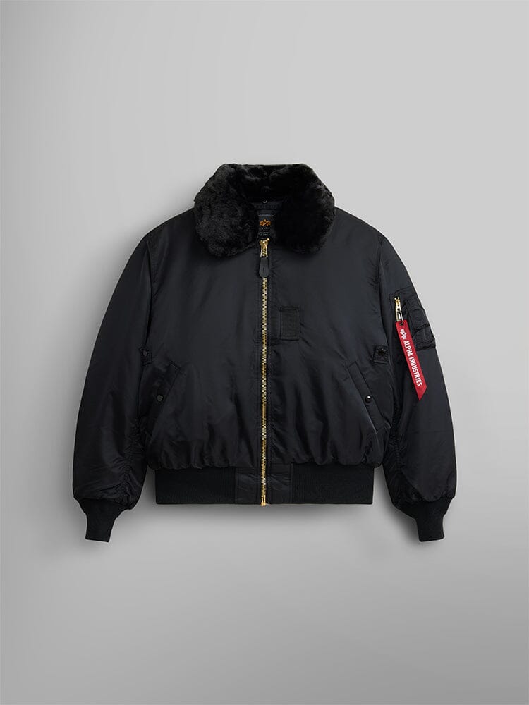 Alpha Industries B-15 Bomber Jacket in black with water-resistant fabric, gold zipper, two front pockets, red Remove Before Flight sleeve tag, and removable faux-mouton collar.