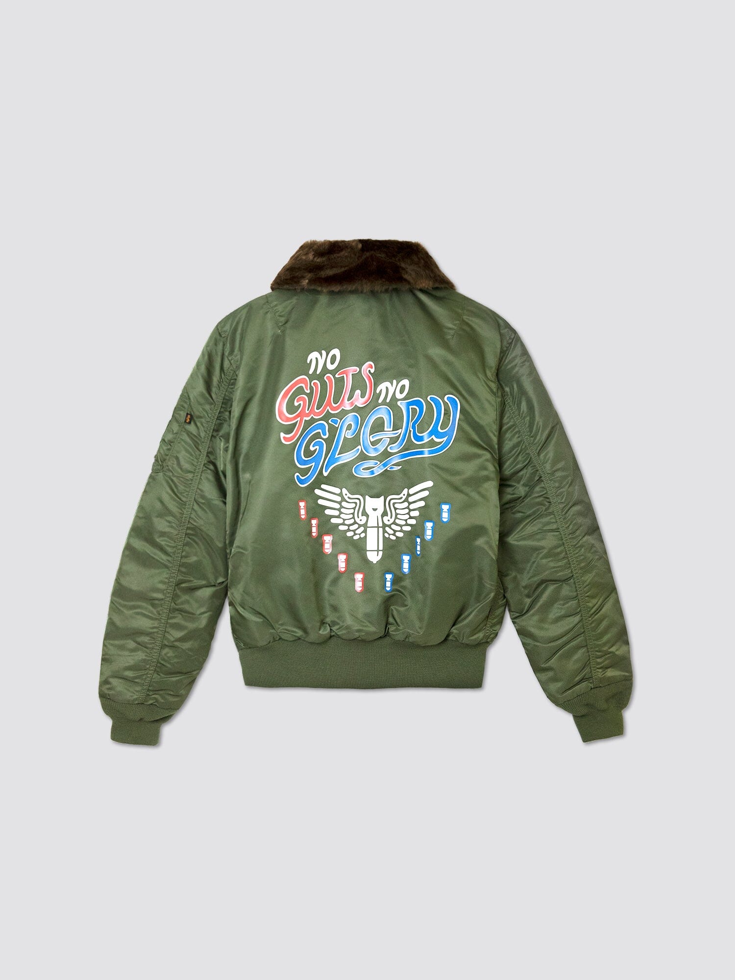 Call of Duty X Alpha B-15 Slim Fit Jacket by Alpha Industries is a green bomber jacket inspired by the B-15 Flight Jacket, featuring "No Guts No Glory" text and a winged emblem on the back. It comes with a fur collar and ribbed hem for a classic look perfect for any Vanguard Task Force mission.