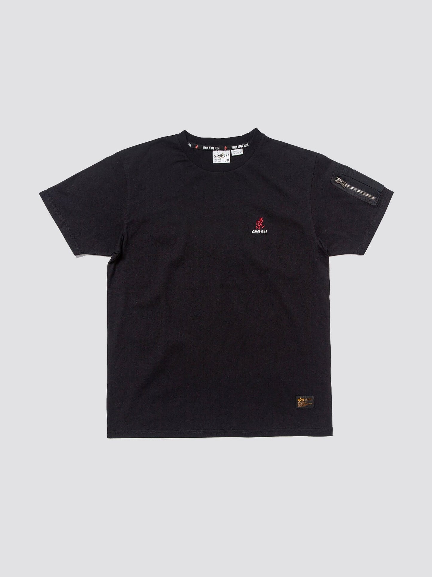 Gramicci X Alpha Cotton Cigar Pocket Tee by Alpha Industries, black cotton tee with small Gramicci logo on chest and zippered utility pocket on left sleeve.