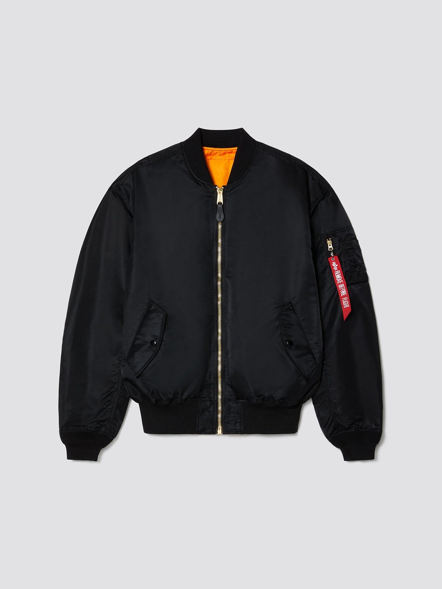 Alpha Industries L-2B Loose Bomber Jacket, black, water-resistant, front zipper, ribbed cuffs and hem, two side pockets, orange lining, red tag on sleeve zipper pocket.