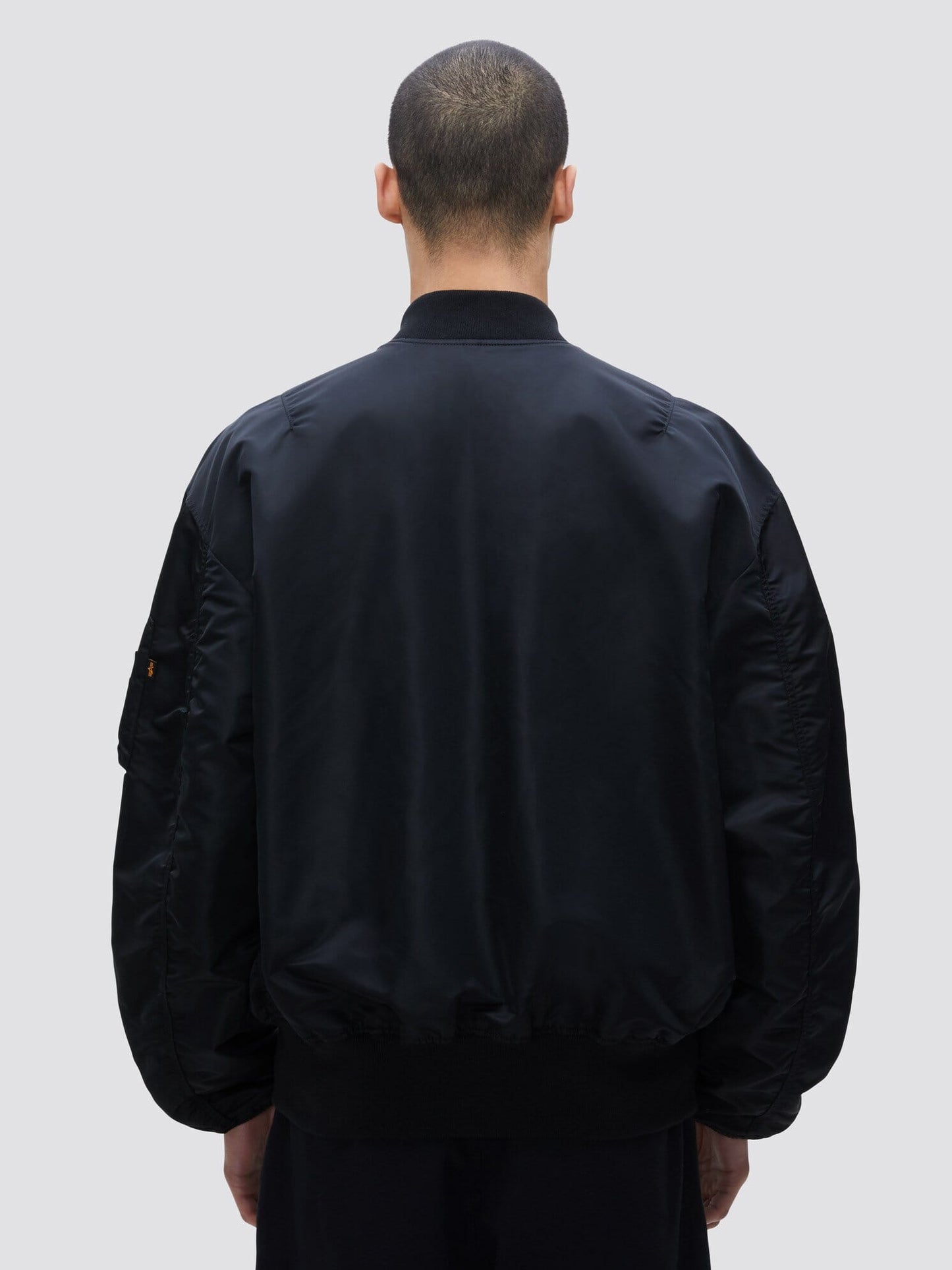 Alpha Industries L-2B Loose Bomber Jacket, black, features loose fit and zip closure.