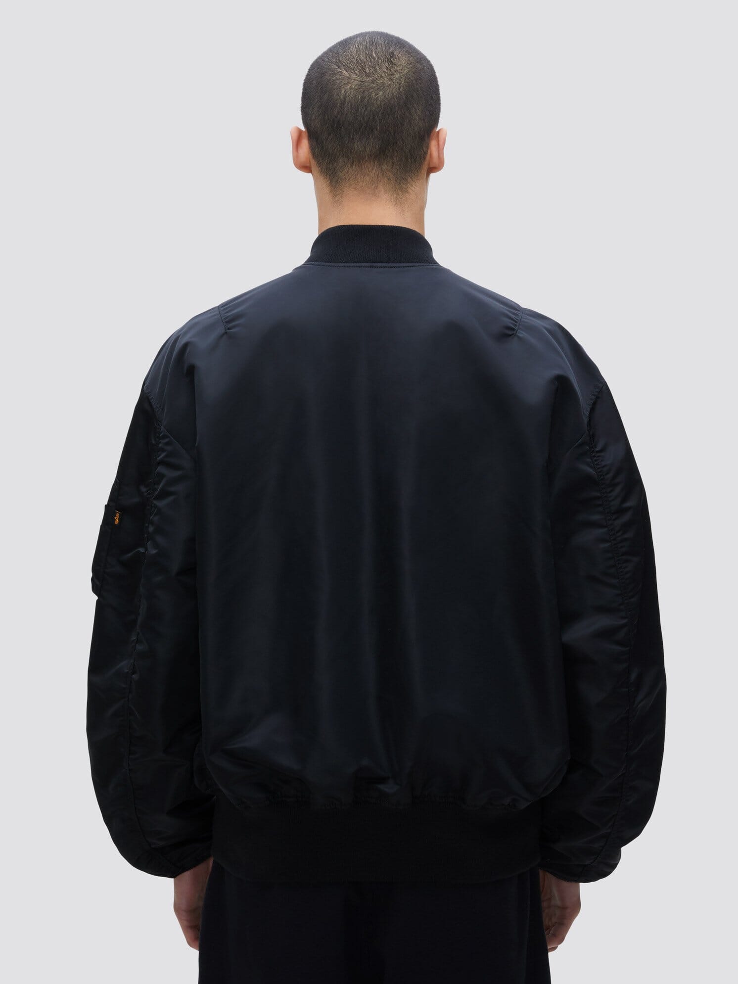 Alpha Industries L-2B Loose Bomber Jacket, black, features loose fit and zip closure.