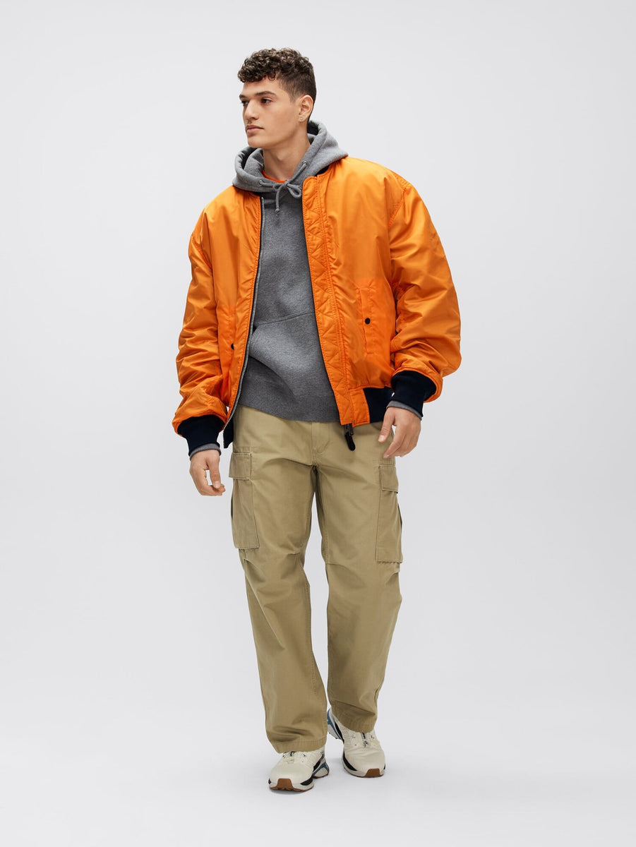 Alpha Industries L-2b Loose Bomber Jacket in orange with front zipper closure.