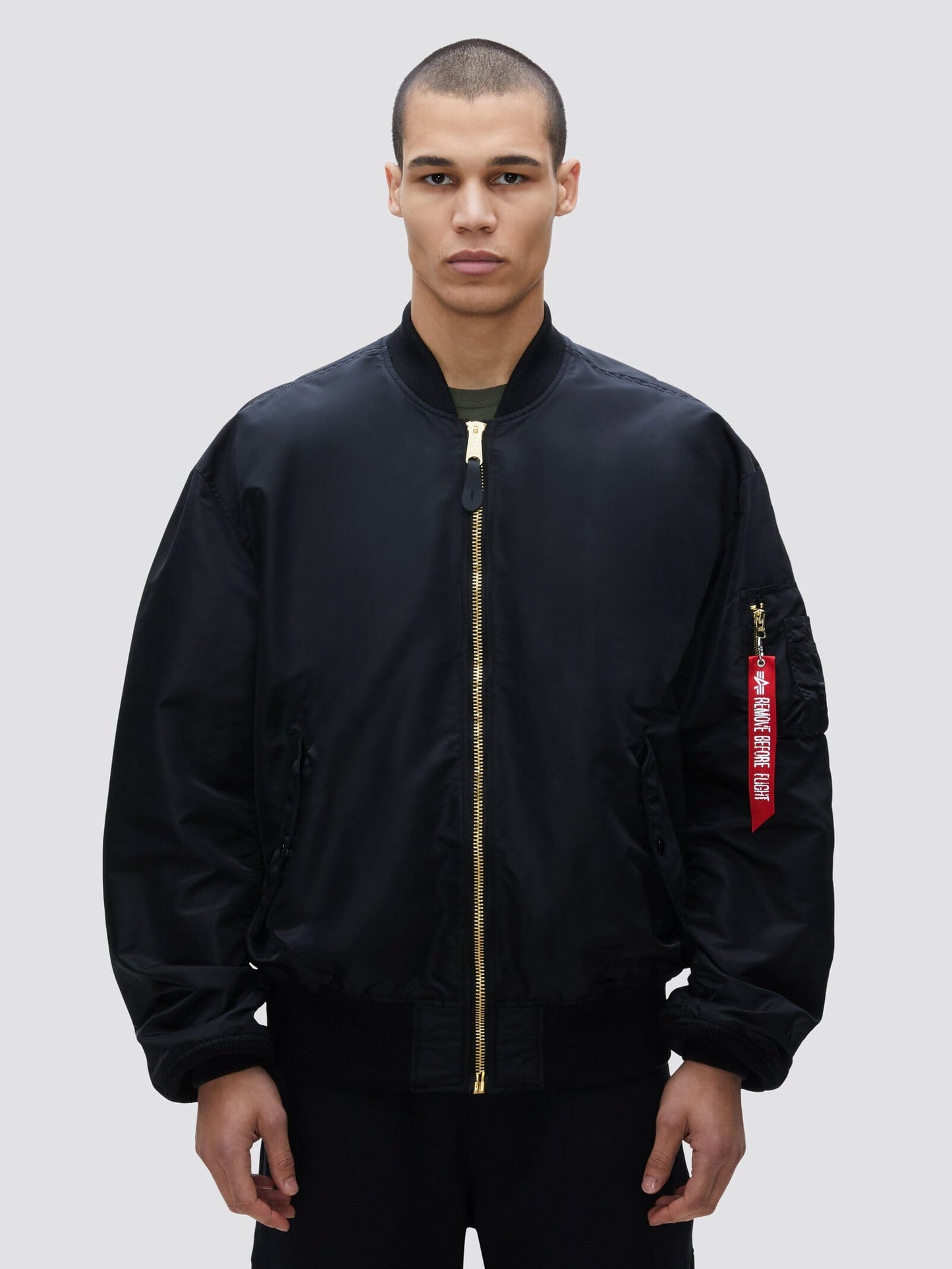 Alpha Industries L-2B Loose Bomber Jacket, black, gold zipper, red sleeve tag.