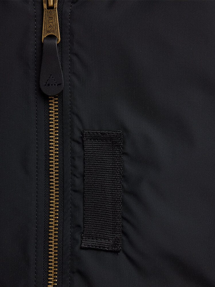 Alpha Industries L-2B Skymaster Gen II Bomber Jacket, black, brass zipper, rectangular fabric patch, signature oxygen tab details.